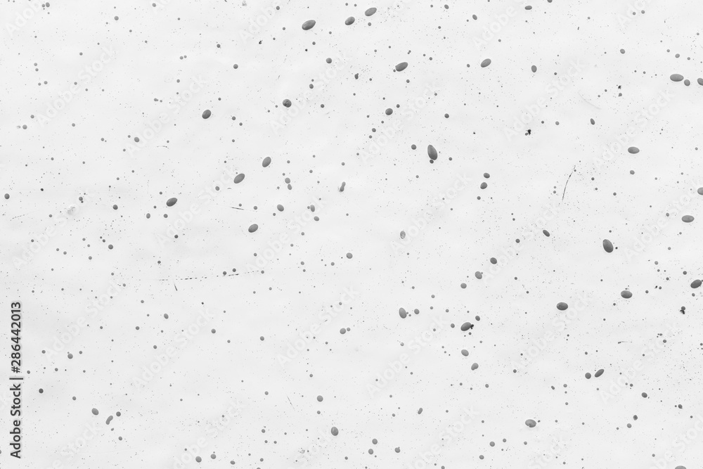 Close-up of a white fiberglass (fibreglass) surface with dots in black and white. High resolution full frame abstract background. Copy space.