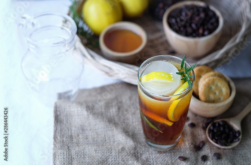Americano iced coffee with lemon and rosemary for healthy drinking 