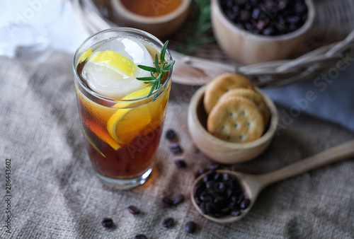 Americano iced coffee with lemon and rosemary for healthy drinking 
