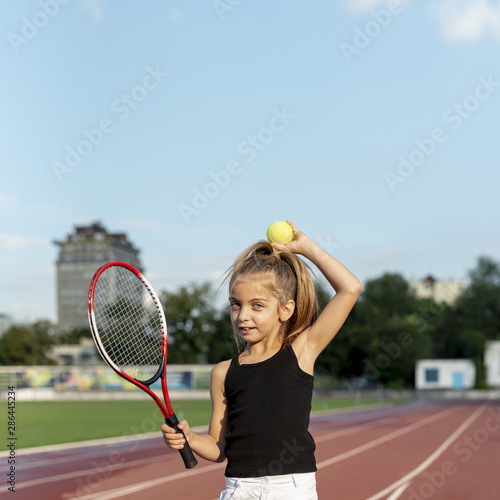Little girl with tennis racket