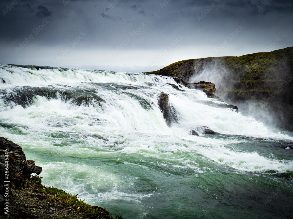 Gullfoss waterfall with dark clouds in Iceland