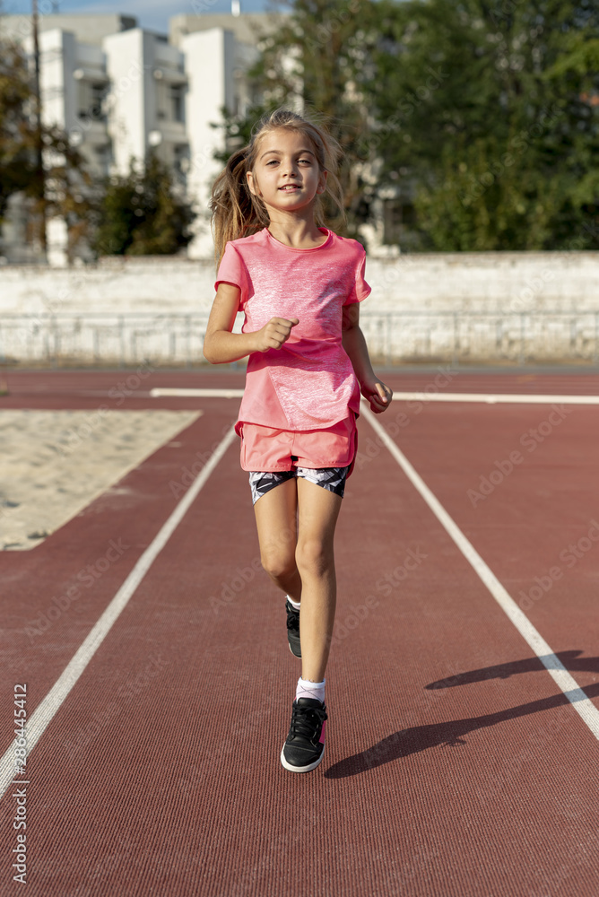 Front view of girl in pink t-shirt running