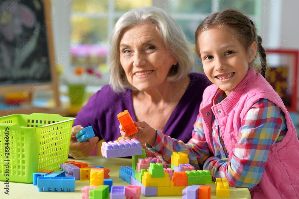 Portrait of grandmother playing with her little granddaughter at home Portrait of grandmother playing with her little granddaughter at home
