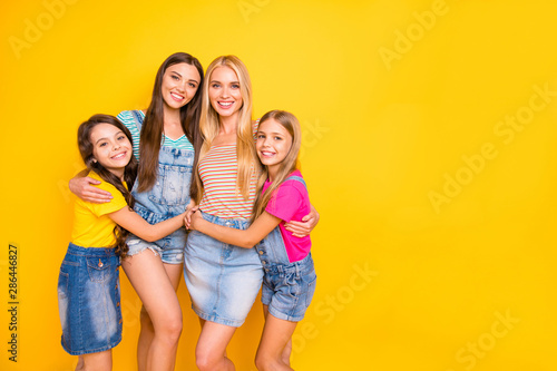 Full length size body photo of four delightful kind nice glad optimistic cheerful ladies enjoying time together isolated vibrant background with copy space