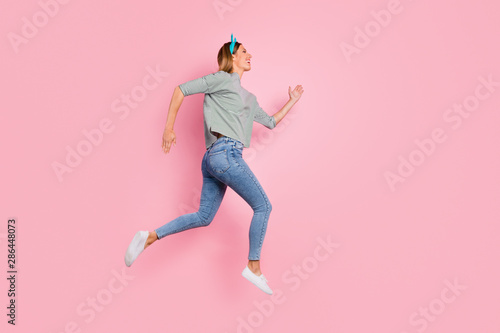 Full length body size profile side view of her she nice attractive lovely cheerful cheery purposeful straight-haired girl running fast long distance free time isolated over pink pastel background