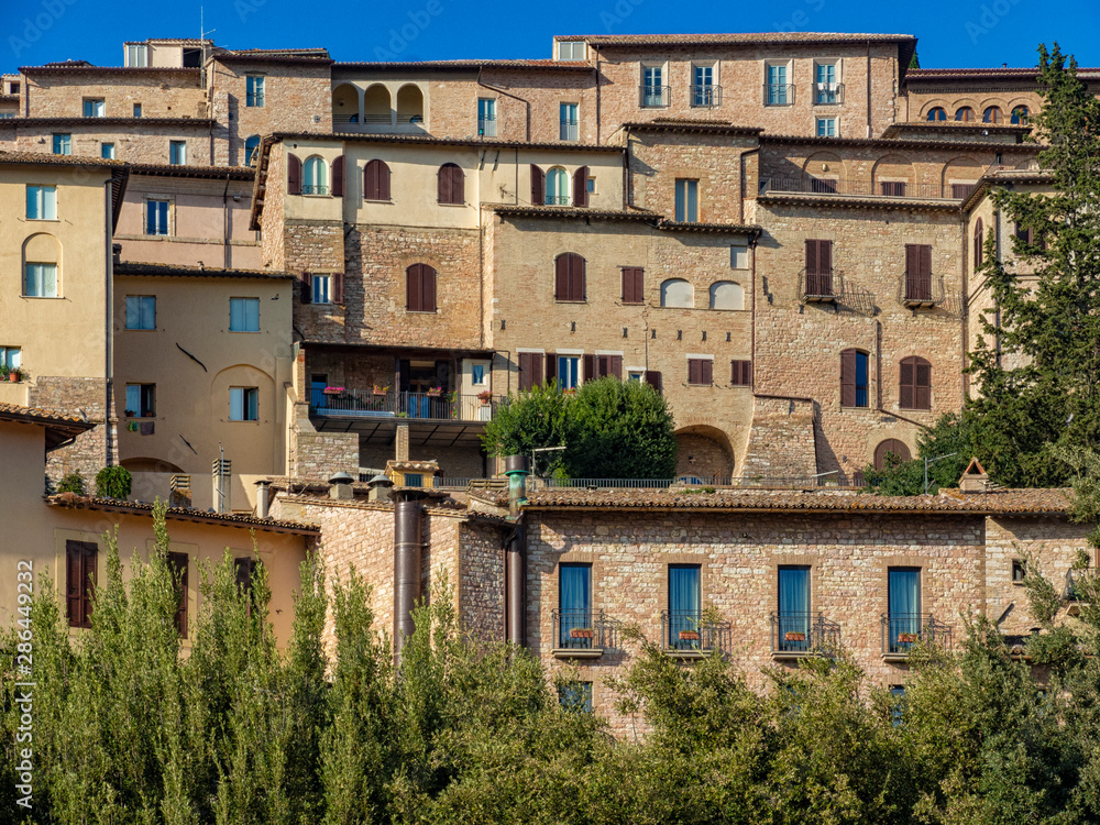 Old houses in Assisi, Italy. Narrow streets of historic town in Umbria, Italy.