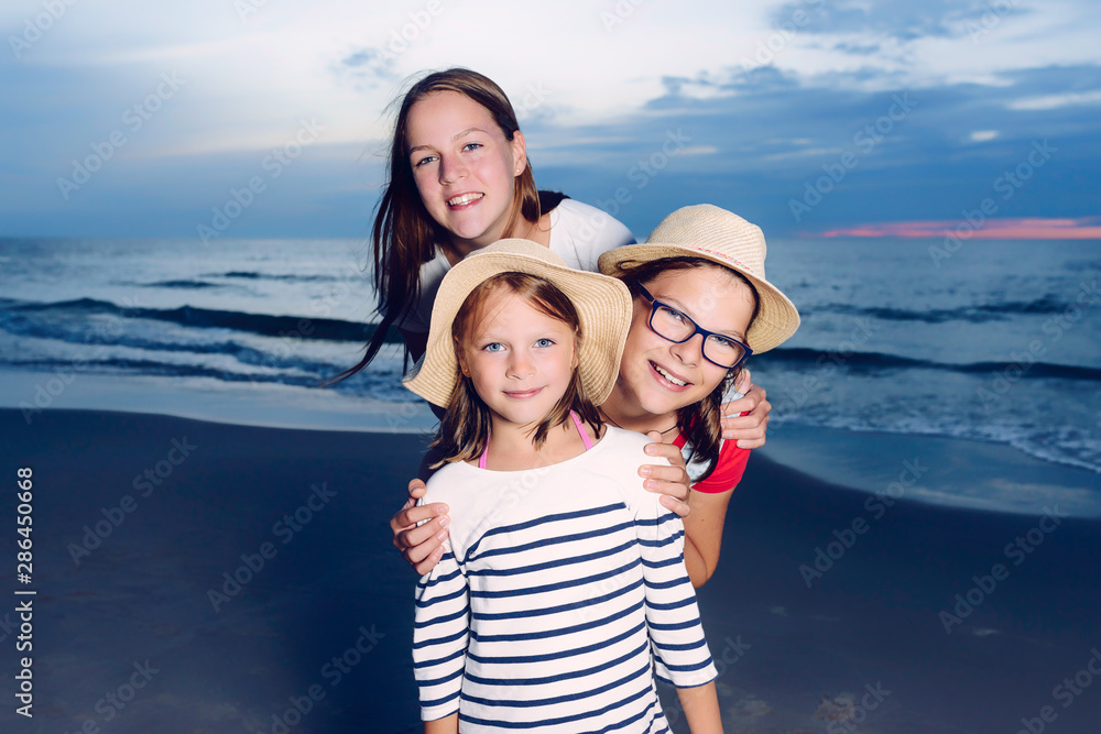 three girls having fun on beach, friends on beach in dusk time