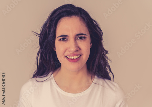 Portrait of beautiful young latin woman with angry and furious face. Human expressions and emotions