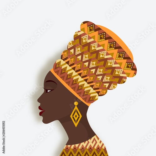 African woman in turban and earrings in profile