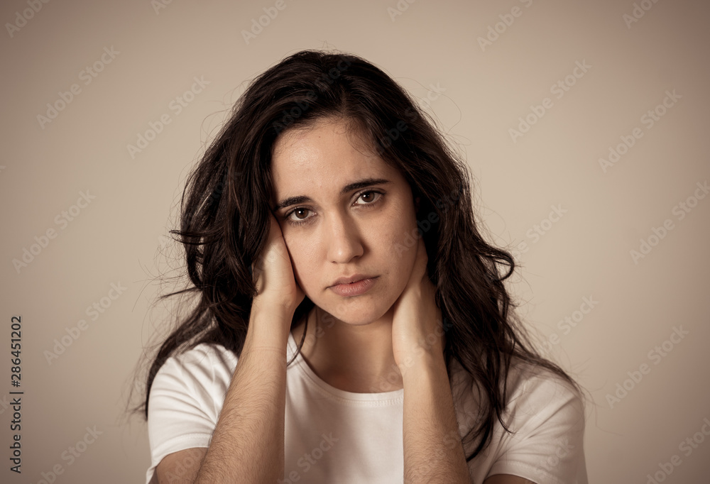 Portrait of sad and depressed woman. Isolated on neutral background. Human expressions and emotions Portrait of sad and depressed woman. Isolated on neutral background. Human expressions and emotions