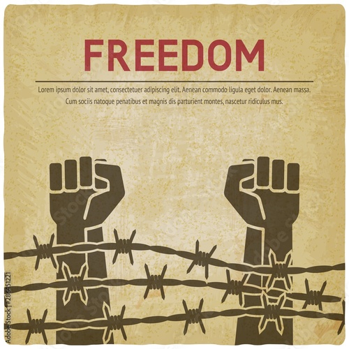 Fighting for freedom concept. Hands clenched into fist behind barbed wire vintage background