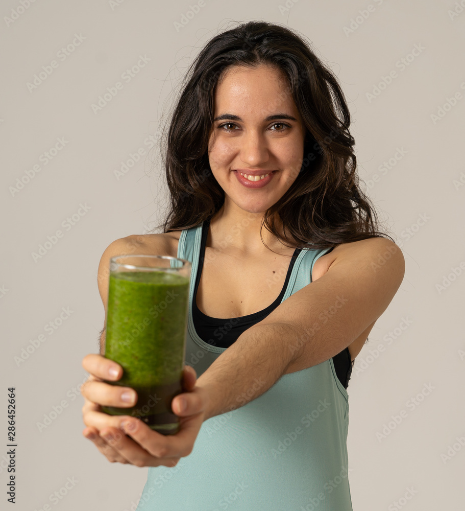 Beautiful fit sport latin woman drinking healthy fresh vegetable smoothie feeling great and healthy Beautiful fit sport latin woman drinking healthy fresh vegetable smoothie feeling great and healthy