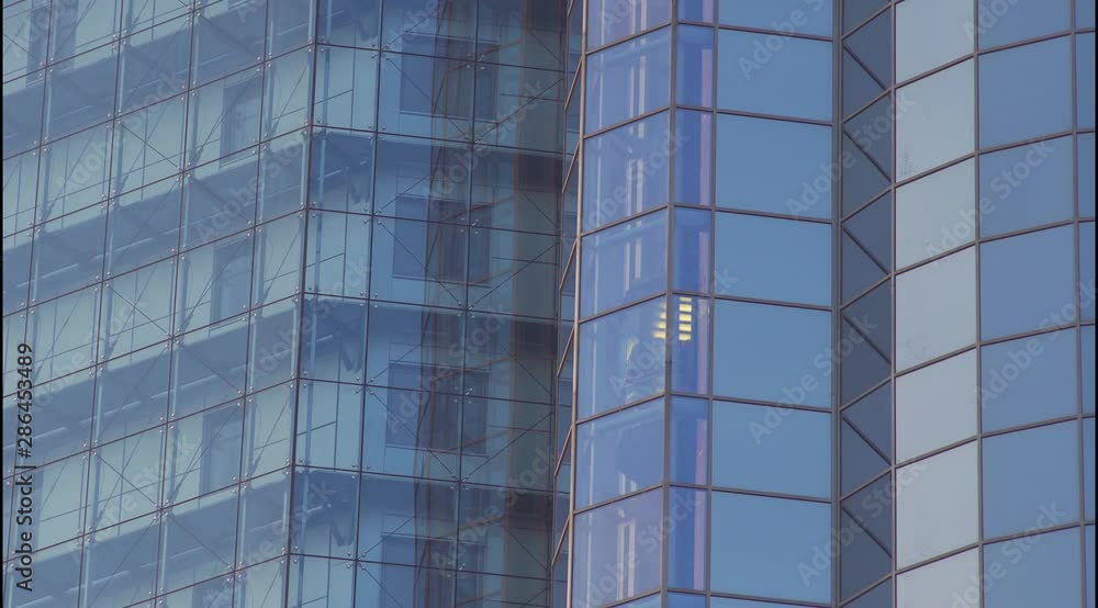 Glass Elevator Going Down the Glazed Facade of Skyscraper. Glass Curtain Facade Wall Background. Glass Elevator Going Down the Glazed Facade of Skyscraper. Glass Curtain Facade Wall Background.