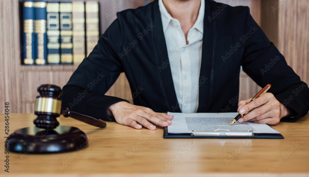Judge gavel with Justice lawyers, Businesswoman in suit or lawyer working on a documents. Legal law, advice and justice concept Judge gavel with Justice lawyers, Businesswoman in suit or lawyer working on a documents. Legal law, advice and justice concept