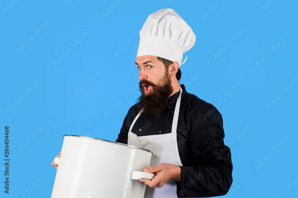 Food, profession and people concept. Cooking pot, saucepan, casserole. Male chef cook holds big pot. Cook man in apron holds saucepan in kitchen. Cookware, dinnerware, kitchenware. Cooking, culinary. Food, profession and people concept. Cooking pot, saucepan, casserole. Male chef cook holds big pot. Cook man in apron holds saucepan in kitchen. Cookware, dinnerware, kitchenware. Cooking, culinary.