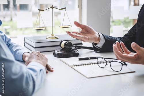 Consultation and conference of Male lawyers and professional businesswoman working and discussion having at law firm in office. Concepts of law, Judge gavel with scales of justice