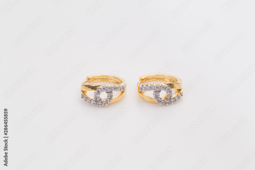 Earrings. Gold Hoop Earrings with diamonds on the white background. Earrings. Gold Hoop Earrings with diamonds on the white background.
