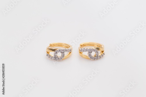 Earrings. Gold Hoop Earrings with diamonds on the white background.