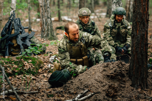 Soldiers on a halt. Preparing for the attack. Digging a trench.