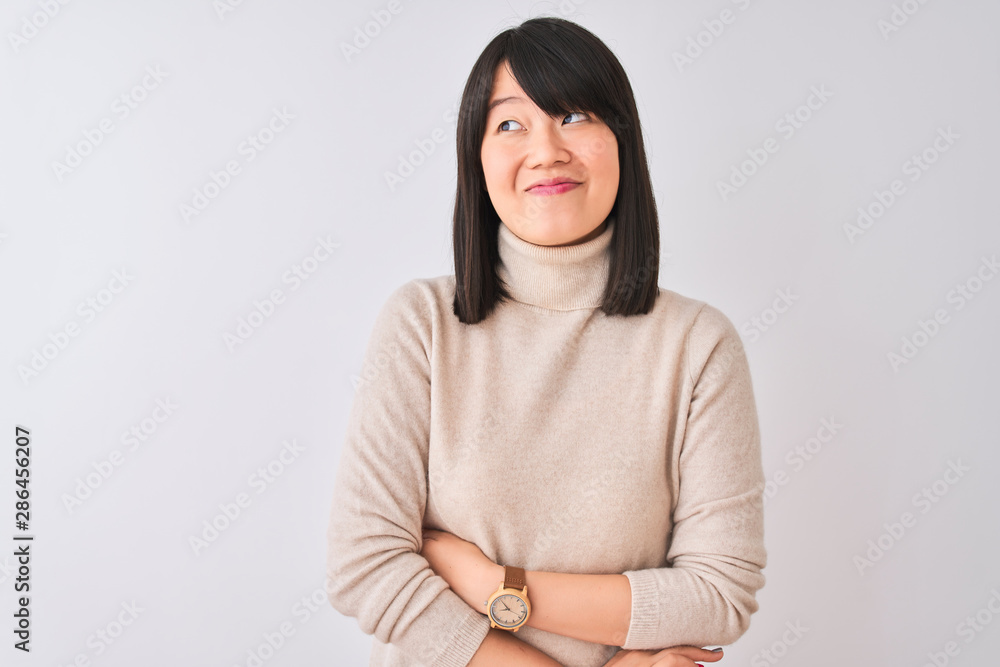 Fototapeta premium Young beautiful chinese woman wearing turtleneck sweater over isolated white background smiling looking to the side and staring away thinking.