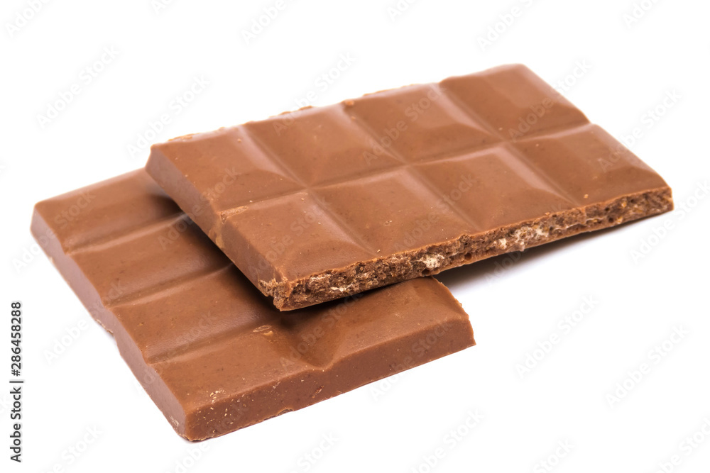 Milk chocolate bar with nut filling in half isolated on white background Milk chocolate bar with nut filling in half isolated on white background