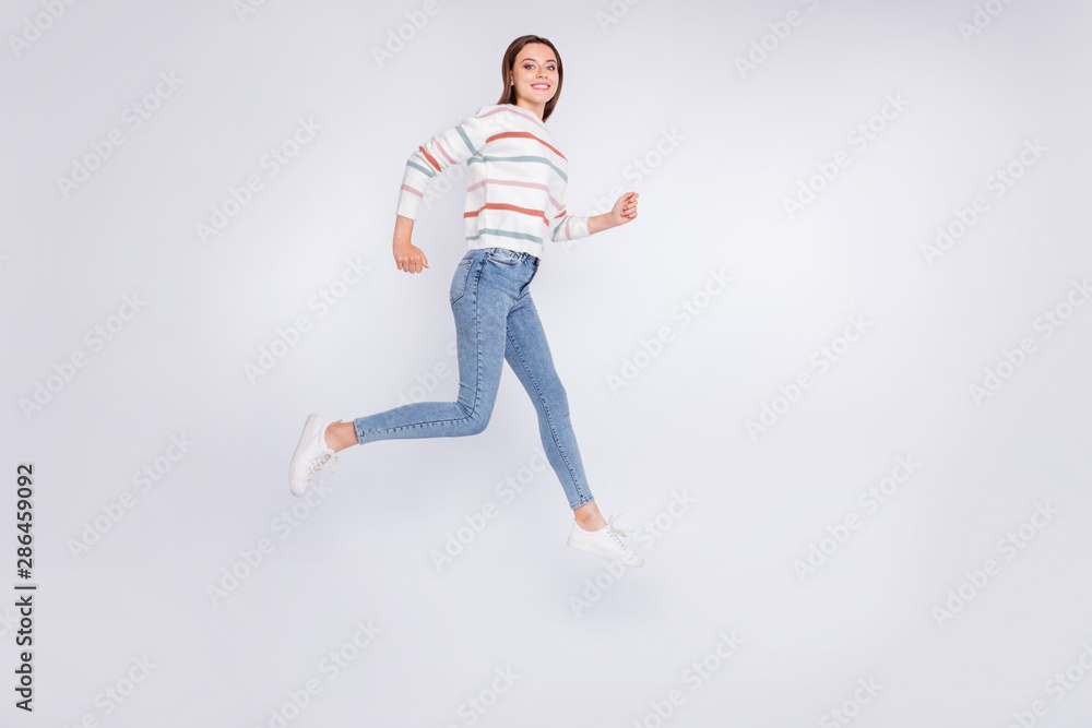Full length photo of lovely youth running smiling wearing striped jumper isolated over white background Full length photo of lovely youth running smiling wearing striped jumper isolated over white background