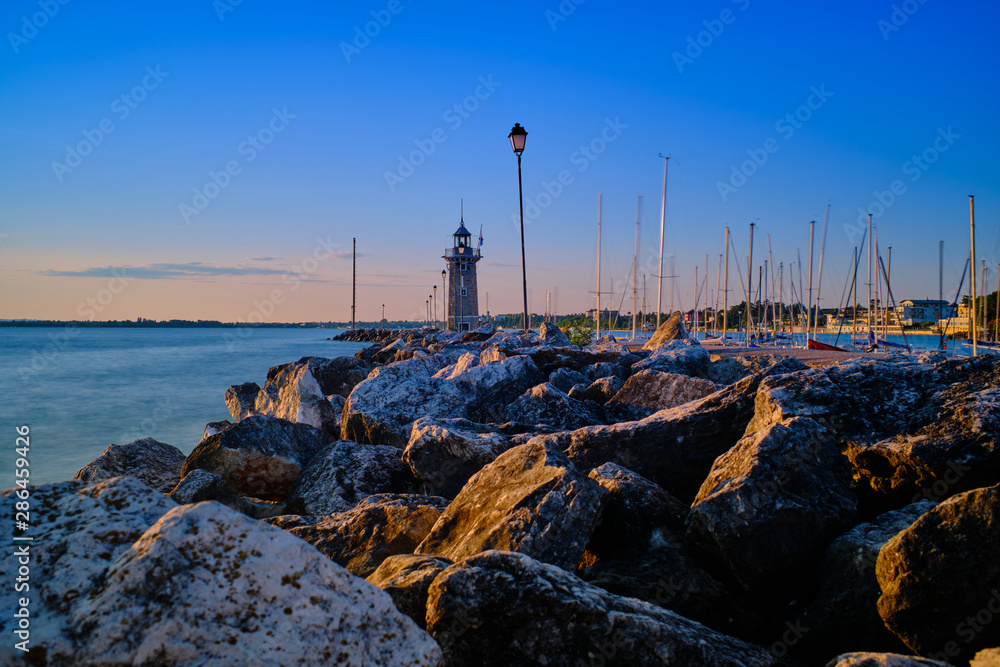 The light brick Italian lighthouse in the port of Desenzano del Garda, Lombardy, Italy.