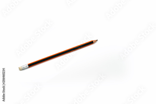 Pencil lies on a white surface isolated on white background.