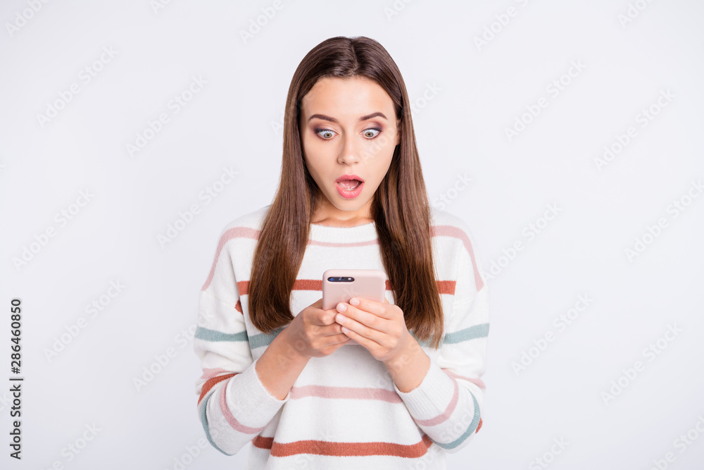 Photo of pretty lady open mouth looking to telephone screen wear striped fluffy pullover isolated white background Photo of pretty lady open mouth looking to telephone screen wear striped fluffy pullover isolated white background