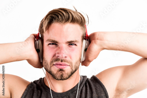 Enjoy every sound. Modern earphones. Pure sound. Inspiring music concept. Excellent sound modern equipment. Man handsome unshaven hipster listening song using headphones gadget white background