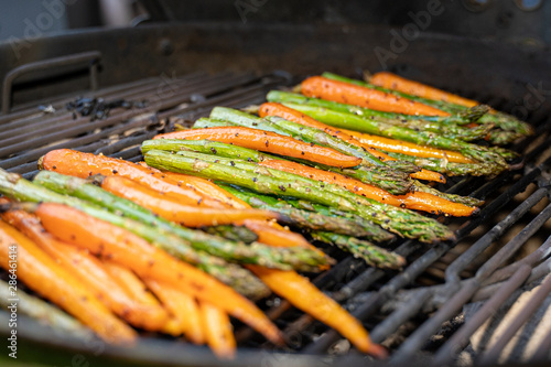 Tastefully fresh green asparagus and orange, carrots prepared, vegetables