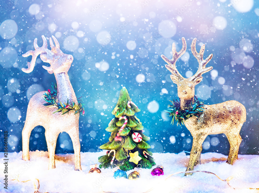 Winter background with deers, christmas tree and snowfall. Merry Christmas and Happy New Year! Winter background with deers, christmas tree and snowfall. Merry Christmas and Happy New Year!