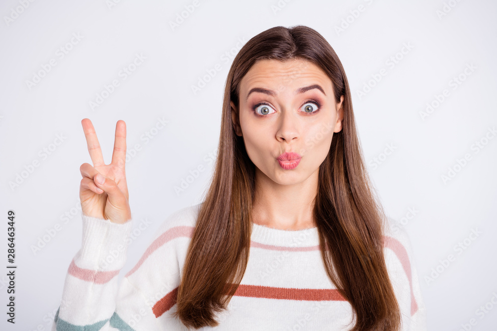 Photo of nice lady showing v-sign symbol sending air kiss wear striped pullover isolated white background Photo of nice lady showing v-sign symbol sending air kiss wear striped pullover isolated white background