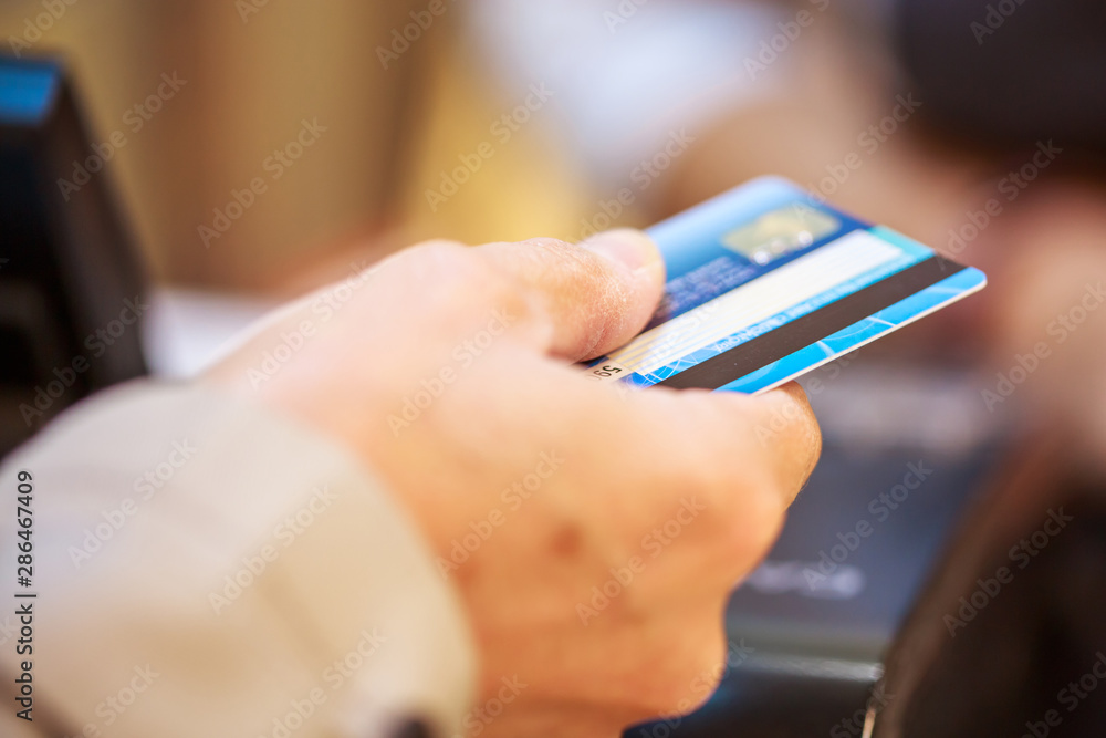 Close-up of female hand doing purchase through payment machine Close-up of female hand doing purchase through payment machine
