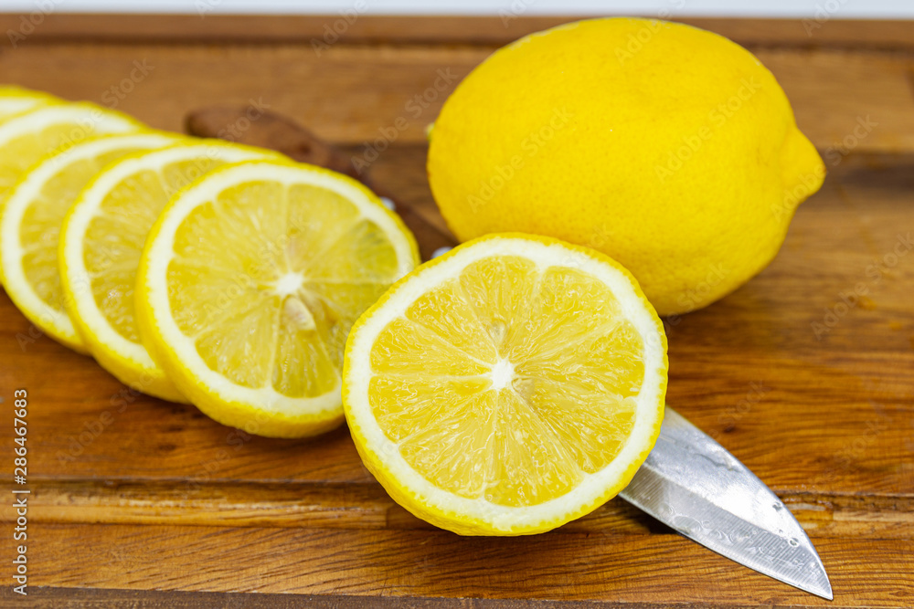 Fresh Fruit Yellow lemon with Half cut on wood for hot summer days and good for health Fresh Fruit Yellow lemon with Half cut on wood for hot summer days and good for health