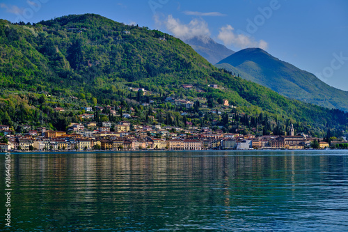  Panoramic view of the center of Salo on Lake Garda, Italy. Reflections of city buildings by the water .