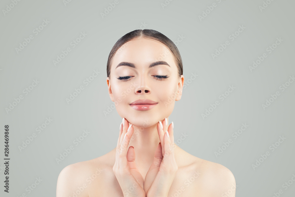 Cute young woman with clear skin relaxing. Skincare and facial treatment concept Cute young woman with clear skin relaxing. Skincare and facial treatment concept