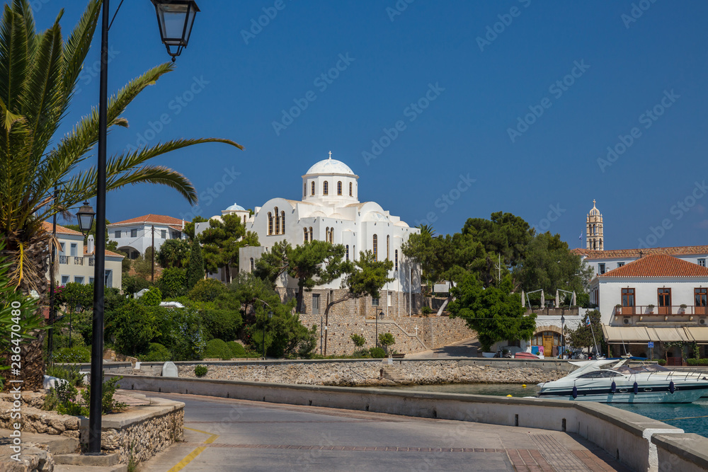 View of the old harbor of Spetses island with the church of St Nicolaos in the background. Saronic gulf, Greece
