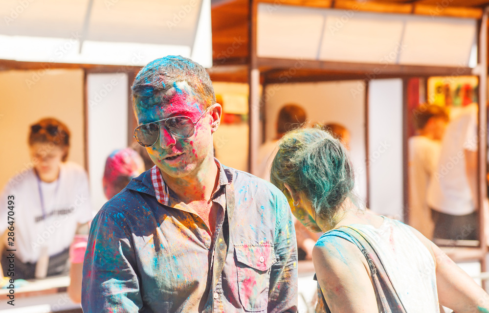 young man with painted face at a paint festival