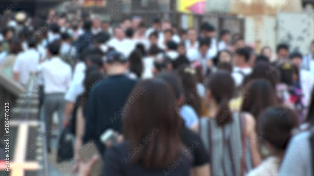 UMEDA, OSAKA, JAPAN - CIRCA JULY 2019 : Blurred view of crowd of people walking down the street in busy rush hour. Many commuter walking near Osaka train station after work. Shot in early evening. UMEDA, OSAKA, JAPAN - CIRCA JULY 2019 : Blurred view of crowd of people walking down the street in busy rush hour. Many commuter walking near Osaka train station after work. Shot in early evening.