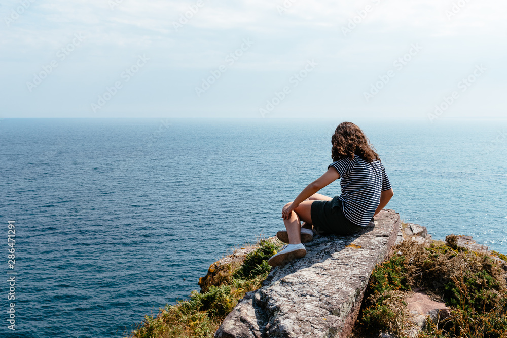Beautiful woman looking at seascape in Brittany
