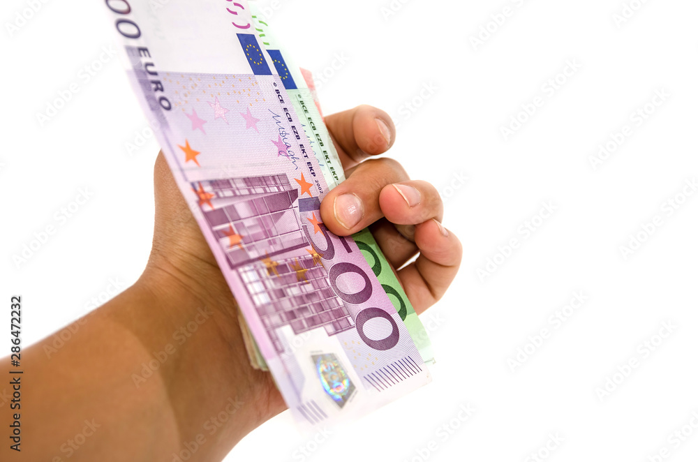Euro banknote in hand isolated on white background. Close-up. Euro banknote in hand isolated on white background. Close-up.