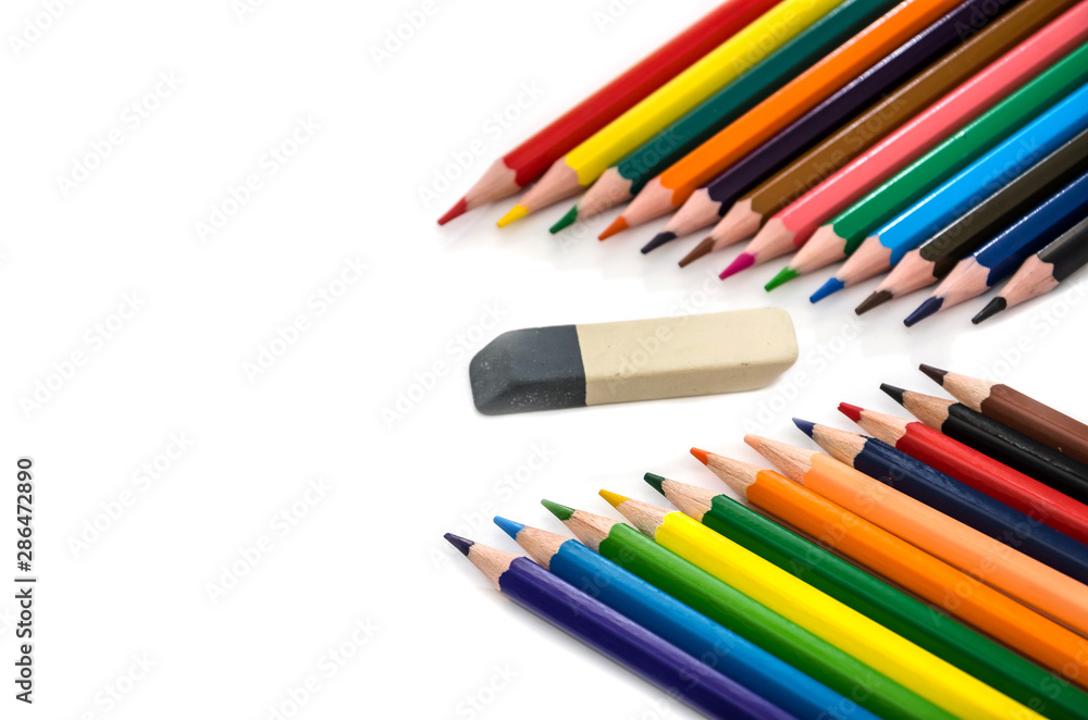 color pencils and eraser on a white background. Place for text. color pencils and eraser on a white background. Place for text.