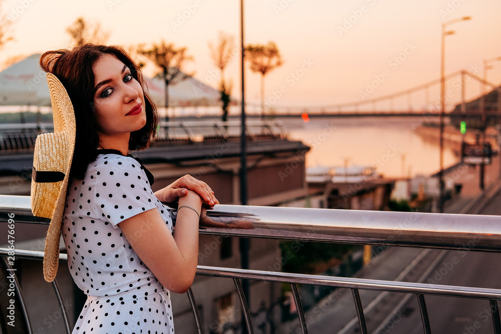 Elegant young lady walking outdoors in the city