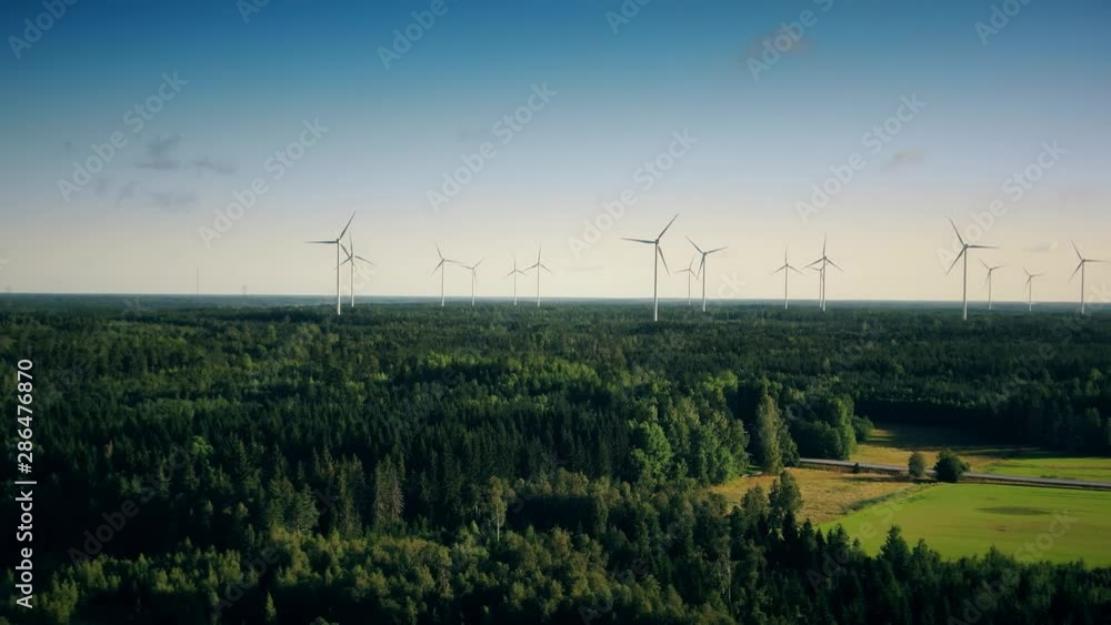 Green electricity generation from wind power in Sweden. Tall towers with large propellers spinning turbines to produce renewable, pollution free energy. Green electricity generation from wind power in Sweden. Tall towers with large propellers spinning turbines to produce renewable, pollution free energy.