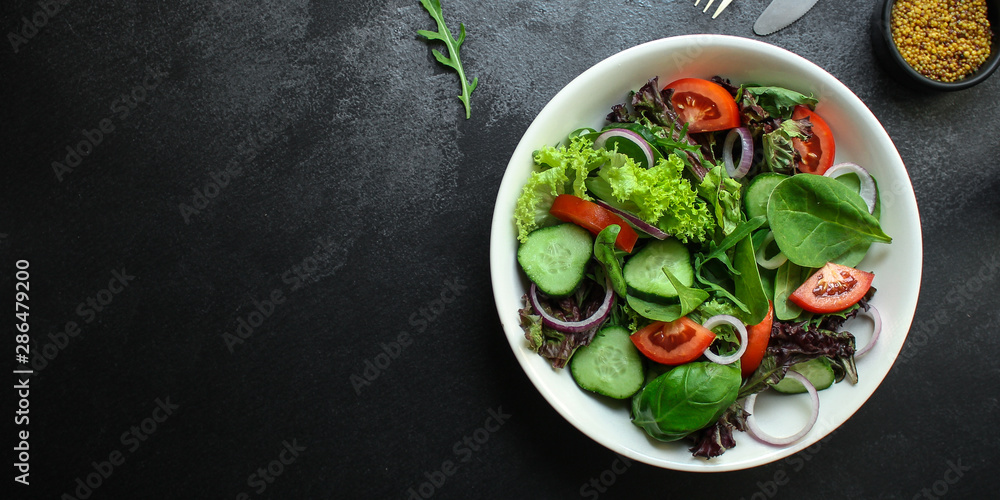 healthy salad (tomato, cucumber, mix leaves, onions and other ingredients) top menu concept. food background. copy space