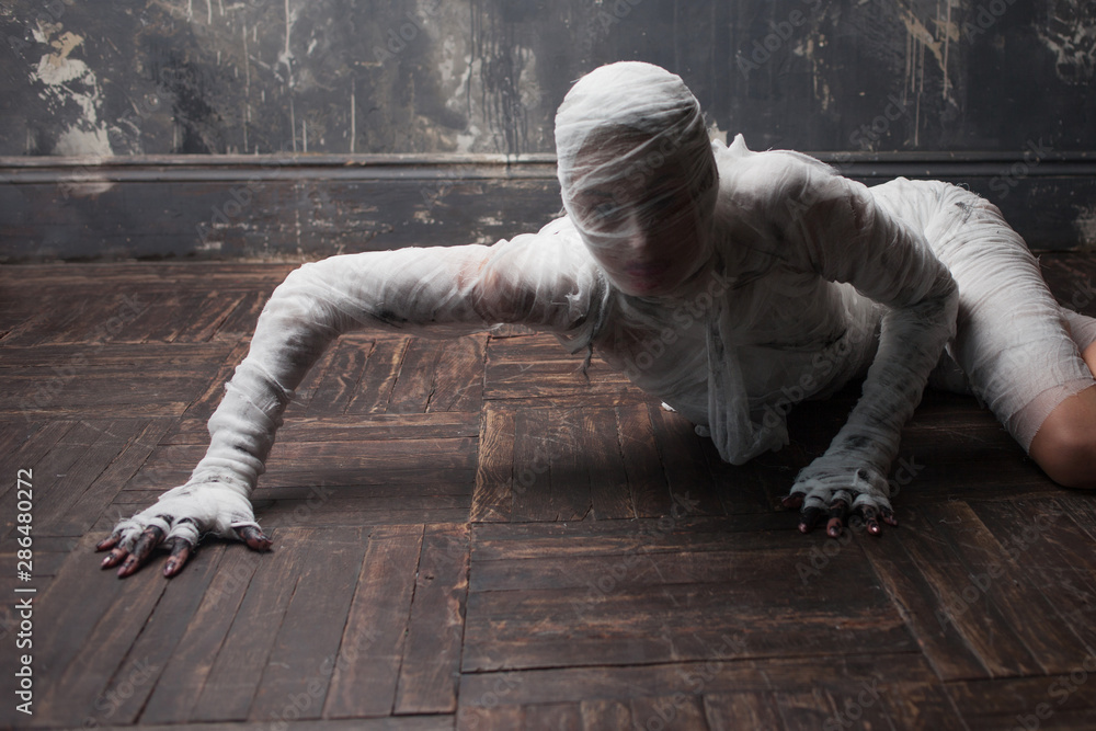 Scary mummy creeps on you. The girl with the bandage Crawling on the floor Scary mummy creeps on you. The girl with the bandage Crawling on the floor