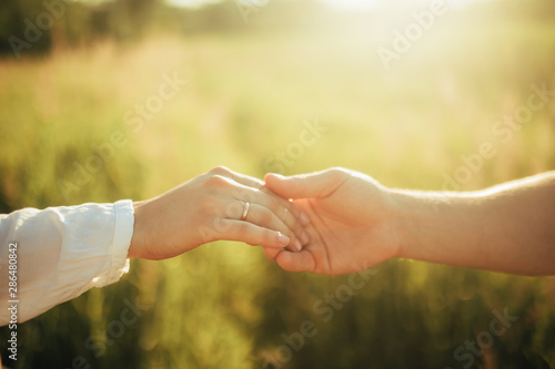 Closeup of male and female hands touching each with other.