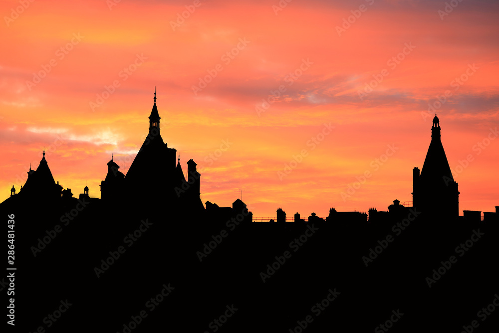 Black silhouette image of the Royal Palace against evening light of twilight sky.