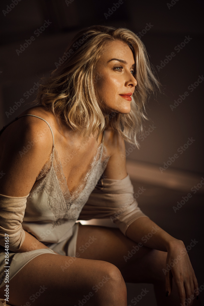 Beautiful woman fashion model posing in silky nightgown. Beautiful woman fashion model posing in silky nightgown.